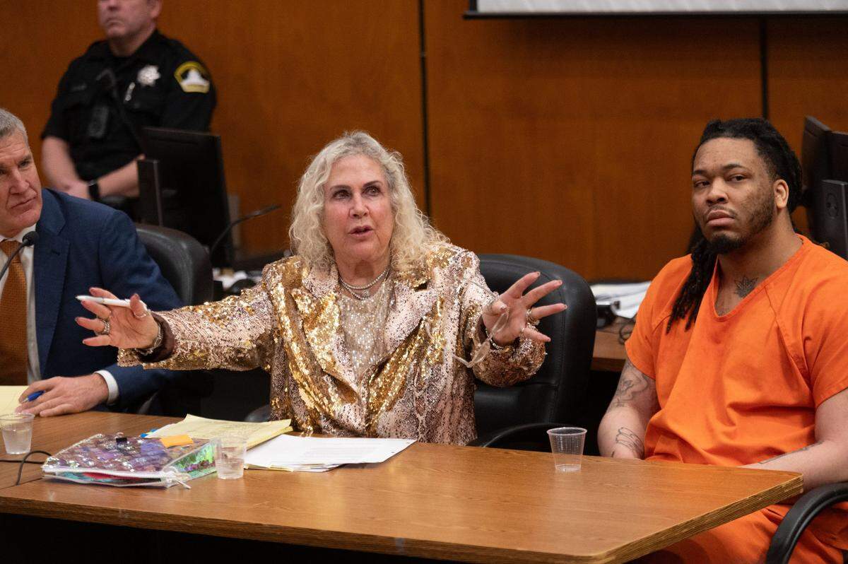 Murder suspect Dandrae Martin listens in Sacramento Superior Court on Friday, Jan. 19, 2024, as defense attorney Linda Parisi, left, talks to a witness during a preliminary hearing with two other suspects in the April 2022 downtown Sacramento mass shooting.