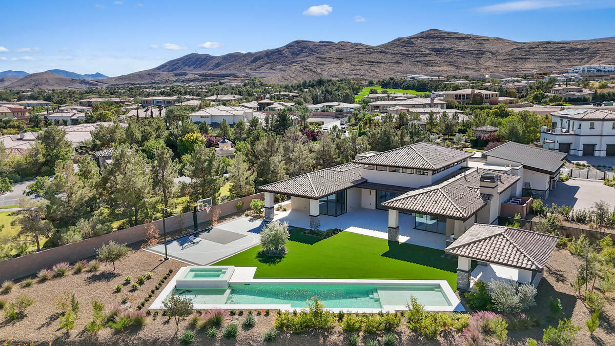 A lap pool, covered grilling aea and half-court basketball court is part of the backyard.
