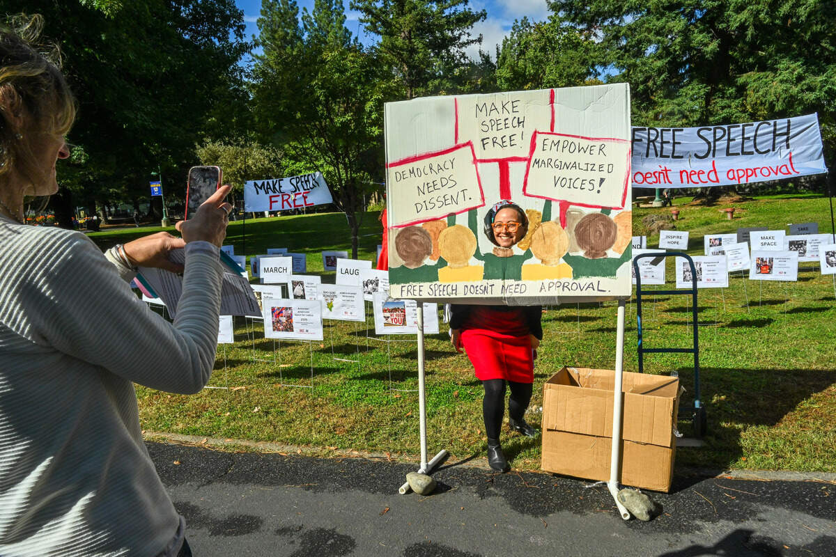 Lina Rincon, an anti-racism and social justice representative for the California Faculty Association, poses for a picture at a protest art installation “Free Speech Doesn’t Need Permission,” at Sacramento State on Thursday.