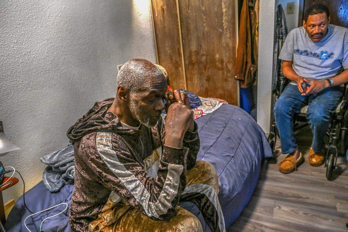 Carlton Franklin wipes tears as Shawn White, another tenant staying in a room nearby, joins him in talking on March 13 about their concern about being evicted from the Auburn Oaks senior housing in Citrus Heights. Franklin later moved to avoid having an eviction in his court records, but his car was towed by police and he is now temporarily living at the X Street shelter in Sacramento. “It’s been a while since I actually smiled,” he said.
