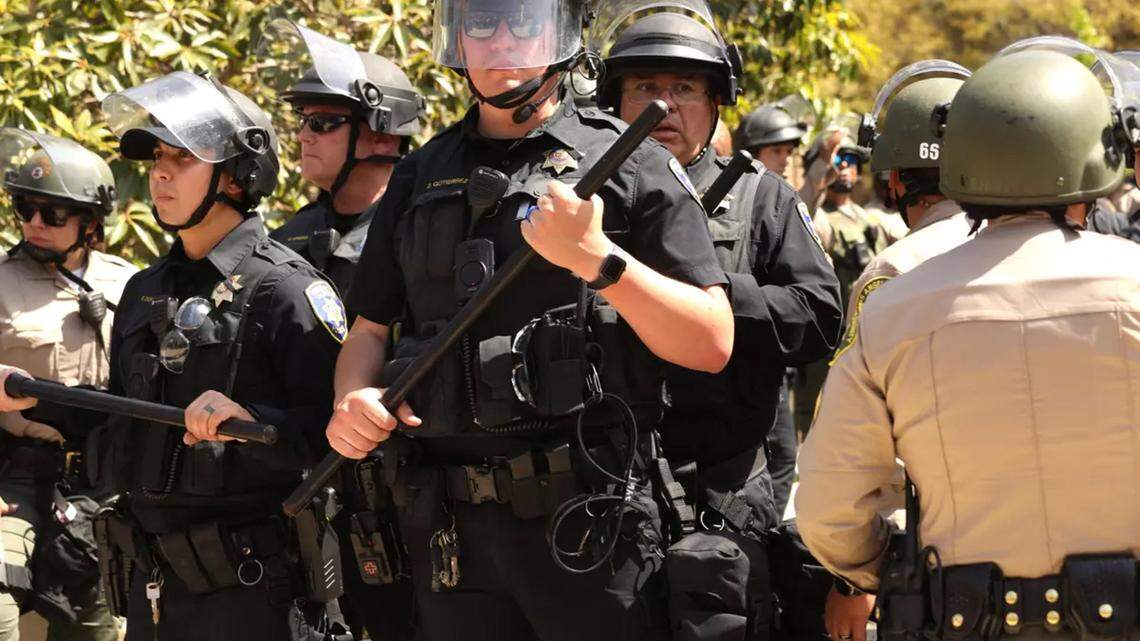 UCLA campus police officers and L.A. County sheriff’s deputies stand guard during the campus protest at UCLA on Thursday, May 2, 2024.