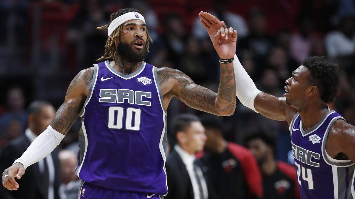 Kings center Willie Cauley-Stein, left, is congratulated by guard Buddy Hield during a game against the Heat in Miami on Monday. The Kings won 123-113.