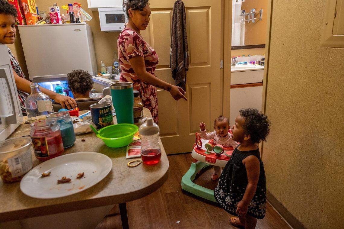 Ashely Patterson and her four children fill the Extended Stay America motel room’s kitchen area in May. “I don’t want to stay in a hotel room forever,” said Patterson, who has to store daughter Angel McDew’s walker in the bathroom. They have been living in the room since August.