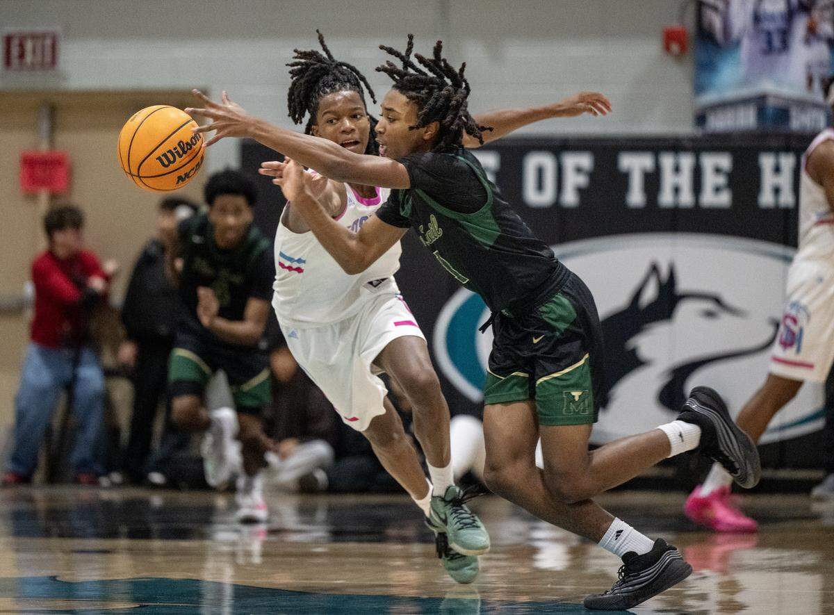 Monterey Trail Mustangs' Aaron Redding (1) picks up a loose ball in front of Sheldon Huskies' Baron Sabir (1) in the first half of a game at Sheldon High School on Wednesday.