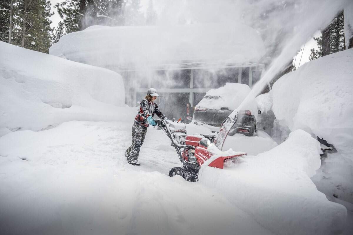 Rylan Travillion, 10, of South Lake Tahoe clears snow from his fanily’s driveway on Monday, March 6, 2023 in South Lake Tahoe. Travillion and his siblings had a snow day, which they will have to make up at the end of the school year. Another 3 to 5 inches snowfall are expected today.
