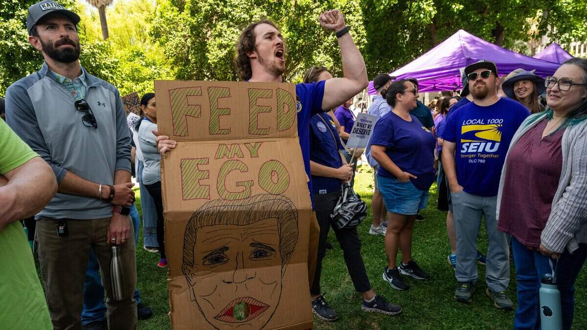 Russ Kinne joins state workers protesting Gov. Gavin Newsom's return-to-office policy during a rally organized by SEIU Local 1000 at the Capitol on Wednesday, July 1, 2026, in Sacramento.