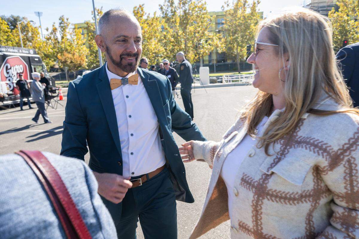 Christopher Cabaldon, the former mayor of West Sacramento and a current California Senate candidate, greets state Sen. Angelique Ashby before a street sign in his honor is revealed Wednesday.