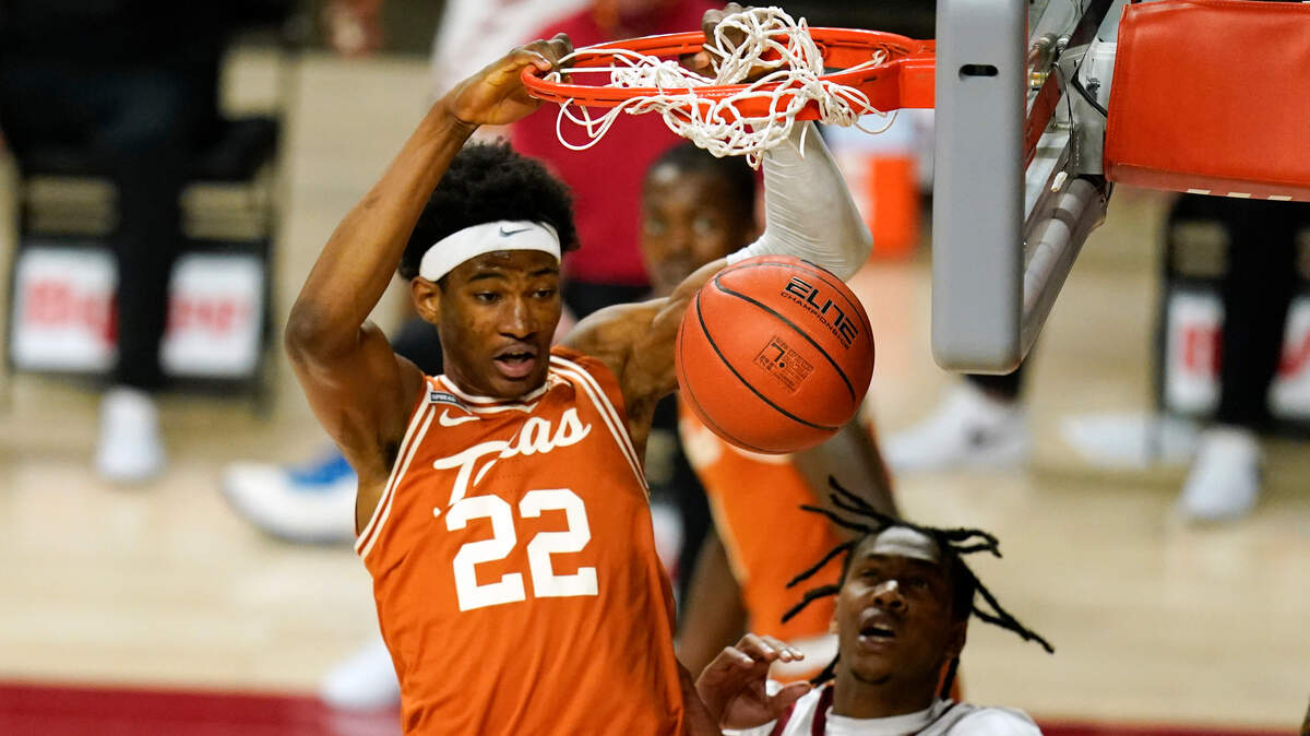 Texas forward Kai Jones (22) dunks the ball during the first half of an NCAA college basketball game against Iowa State, Tuesday, March 2, 2021, in Ames, Iowa. (AP Photo/Charlie Neibergall)