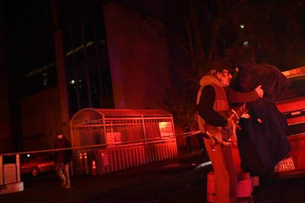 Residents of the Edgewater senior apartment tower in downtown Sacramento are evacuated by Sacramento Fire Department personnel on Tuesday, Dec. 14, 2021. The Edgewater was evacuated several hours after power to the building was severed by a nearby substation fire.
