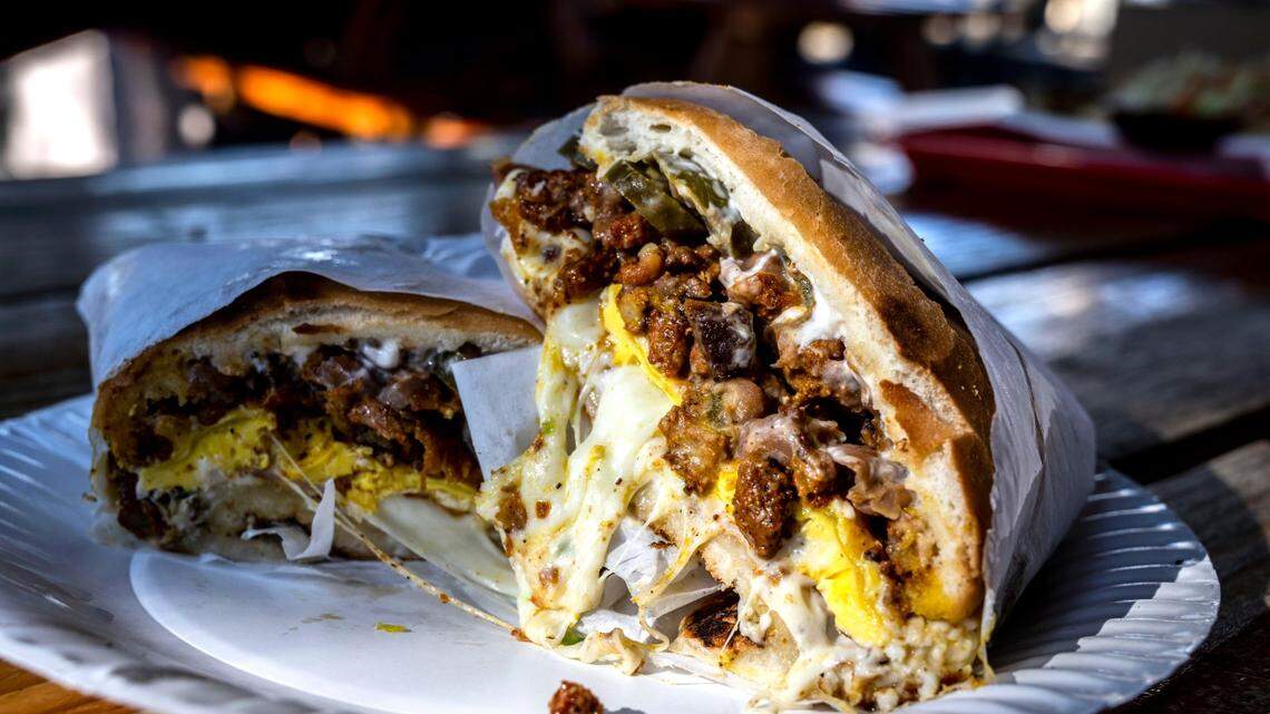 Pupusería La Chicana’s torta Cubana with its adobada, carne asada, ham, cheese, fried egg, beans and pickled jalapeños, sits ready to eat on Wednesday, Nov. 16, 2022 in Woodland.