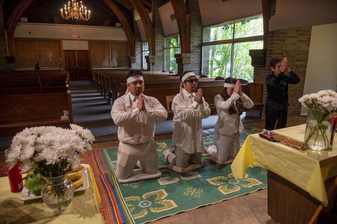 At Dung Tan Nguyen’s funeral, family members, from left, Michael Chambon, Bao Nguyen, Trang Nguyen and Kim Anh Dinh, chant a Buddhist prayer, on Wednesday, May 6, 2020, during a service that would have been full of family and community members if it wasn’t for the safety precautions put in place to protect against the coronavirus.