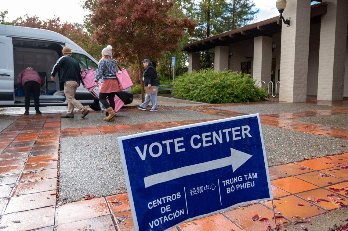 Election officials load ballot boxes into a Sacramento County van at a vote center at Folsom Community Center on Tuesday, Nov. 8, 2022.