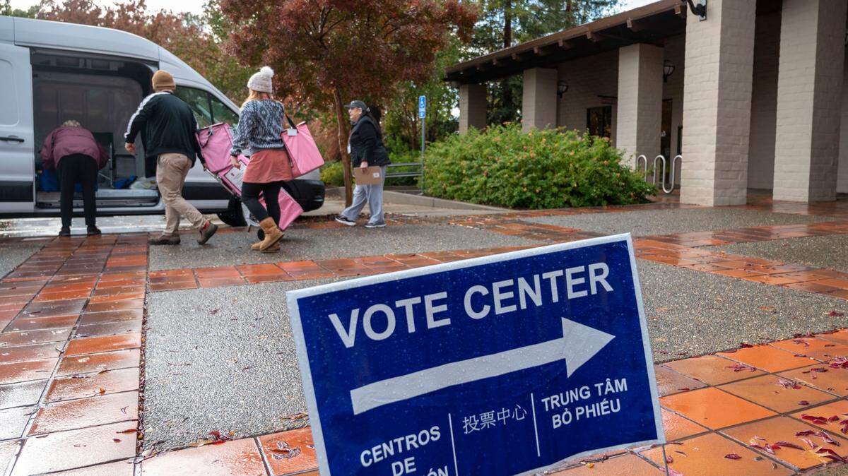 Election officials load ballot boxes into a Sacramento County van at a vote center at Folsom Community Center on Tuesday, Nov. 8, 2022. 