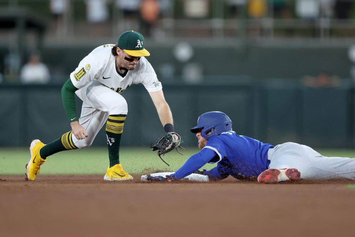 Jul 12, 2025; West Sacramento, California, USA; Toronto Blue Jays center fielder Myles Straw (3) slides safely before Athletics shortstop Jacob Wilson's (5) tag during the fifth inning at Sutter Health Park. Mandatory Credit: Dennis Lee-Imagn Images