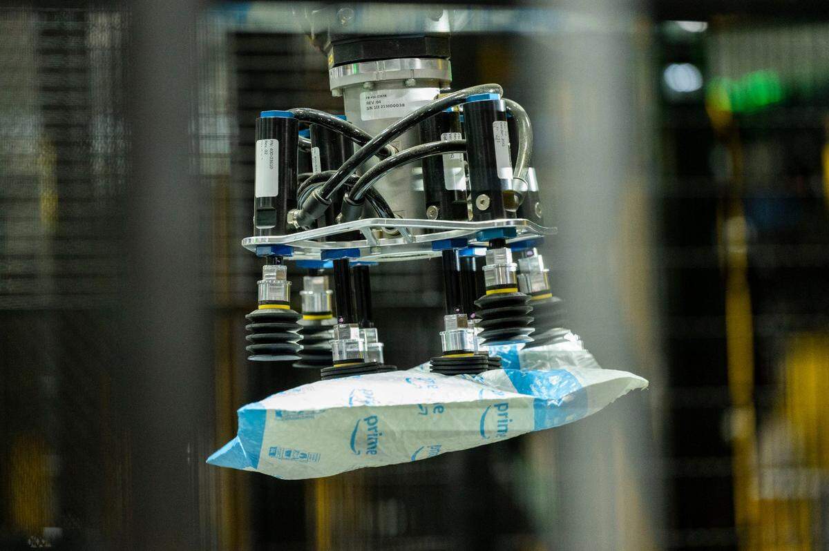 A robotic arm prepares to release a suction-gripped package at the Amazon fulfillment center in Tracy on Friday.