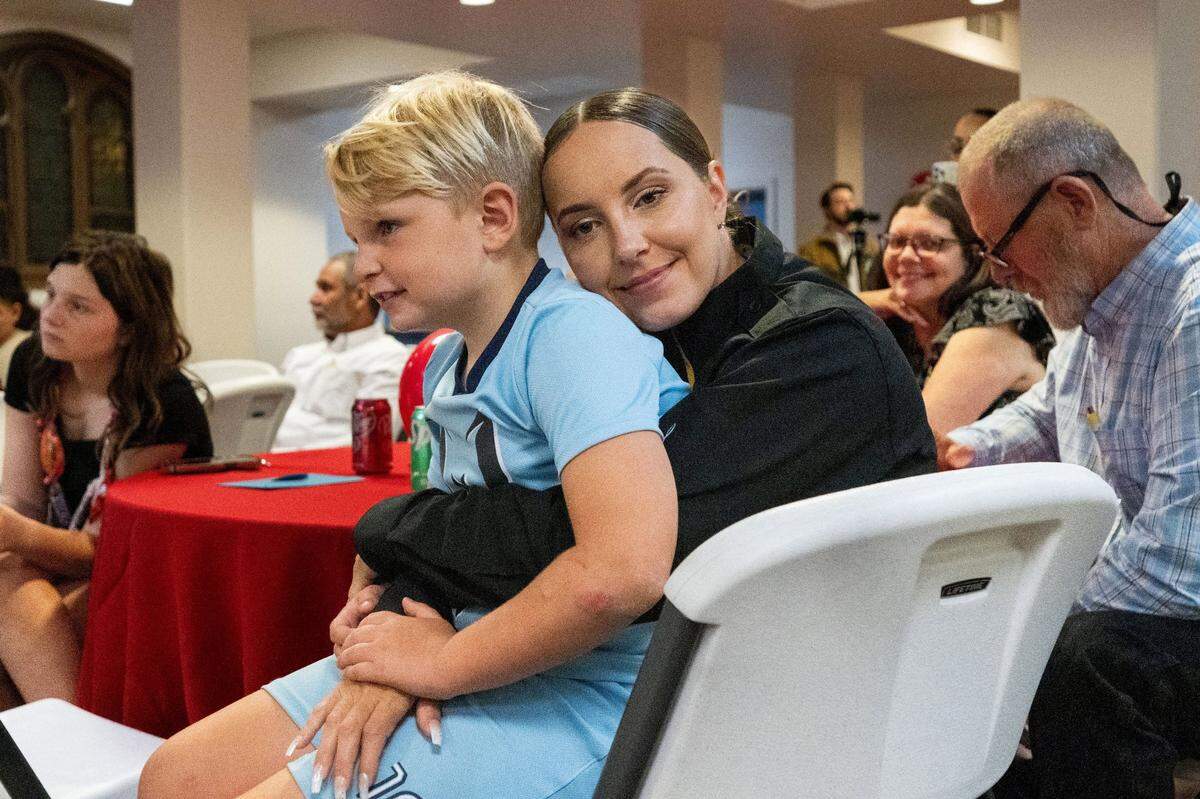 Graduate Chelsey Sylva hugs her seven-year-old son Cash as she participates in a Sacramento graduation ceremony on Tuesday for a first-ever program to train female inmates to become firefighters.