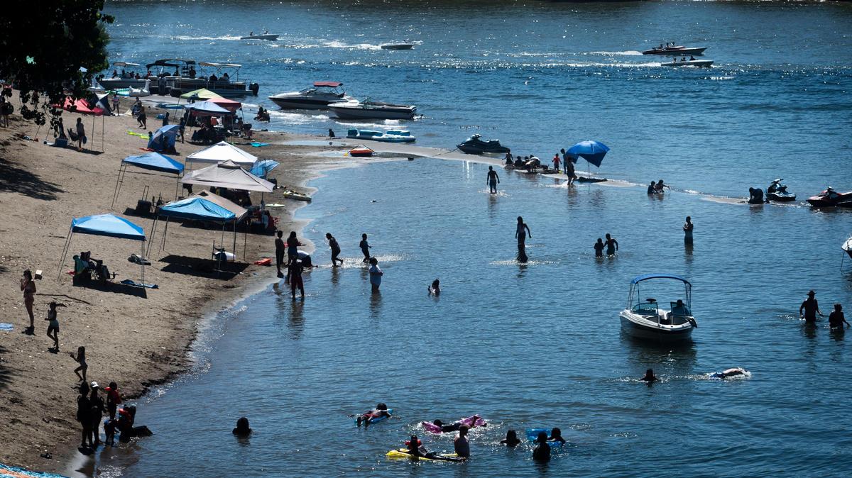 Discovery Park goers enjoy a dip in the American River during a hot day at Tiscornia Beach, Sunday, September 1, 2019.