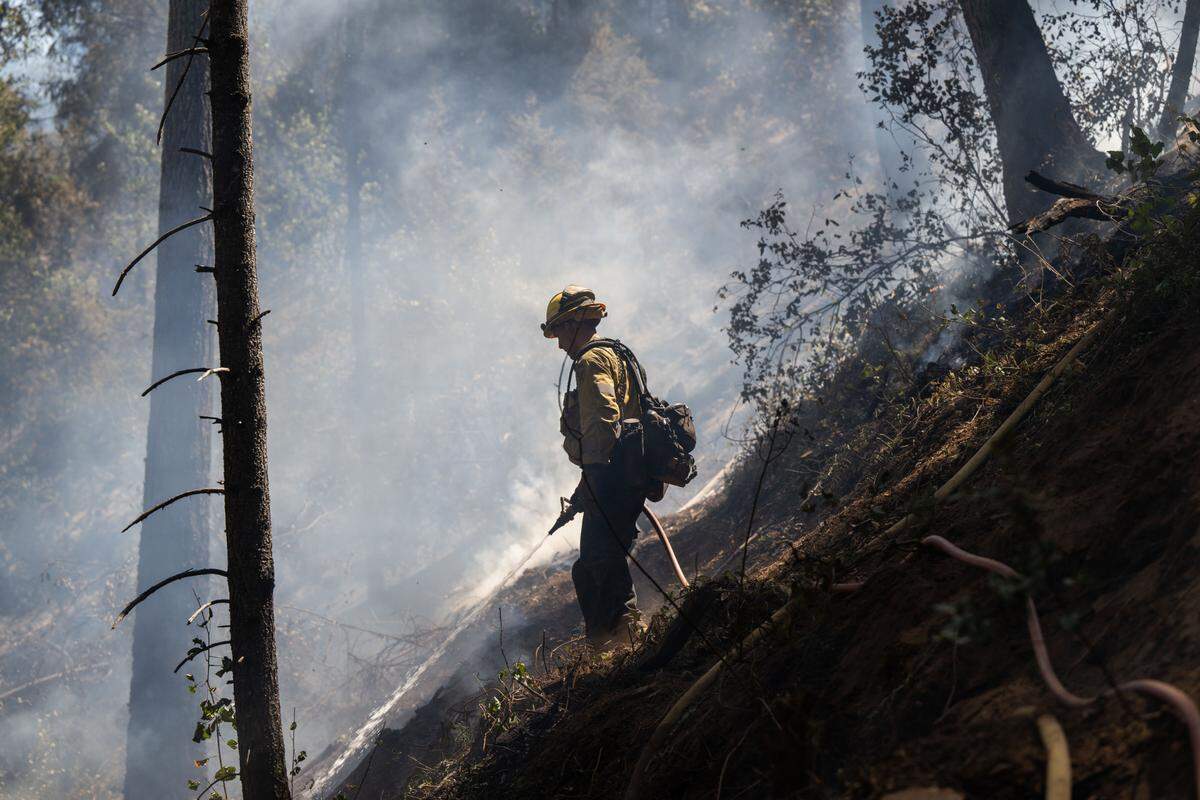 Cal Fire firefighter Eric Schnetz of Georgetown works to extinguish the Crozier Fire in El Dorado County on Wednesday, Aug. 7, 2024.