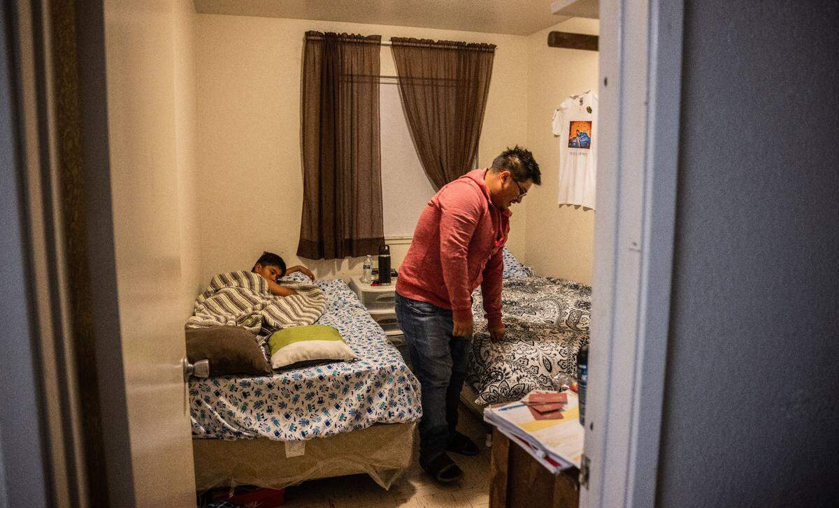 Carlos Alfonso Perez gets ready at the Lodi Migrant Housing Center, where he lives with his family, to go to work at a nearby vineyard in August.