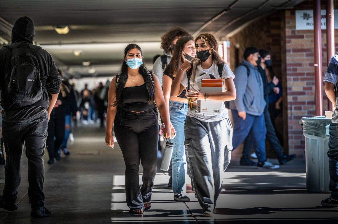 Melanie Maldonado, left, and Maria Barrosa, both seniors at Hiram Johnson High School in Sacramento, wear their masks on June 6, as they walk the hallway between classes on the first day of a return to mandatory indoor masking at the Sacramento City Unified School District.