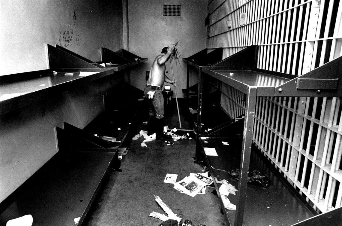 A man cleans a cell in the old jail on May 16, 1989.