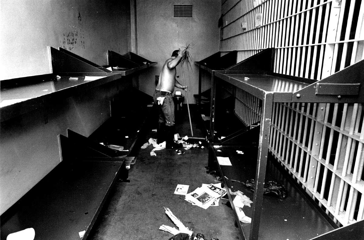 A man cleans a cell in the old jail on May 16, 1989.