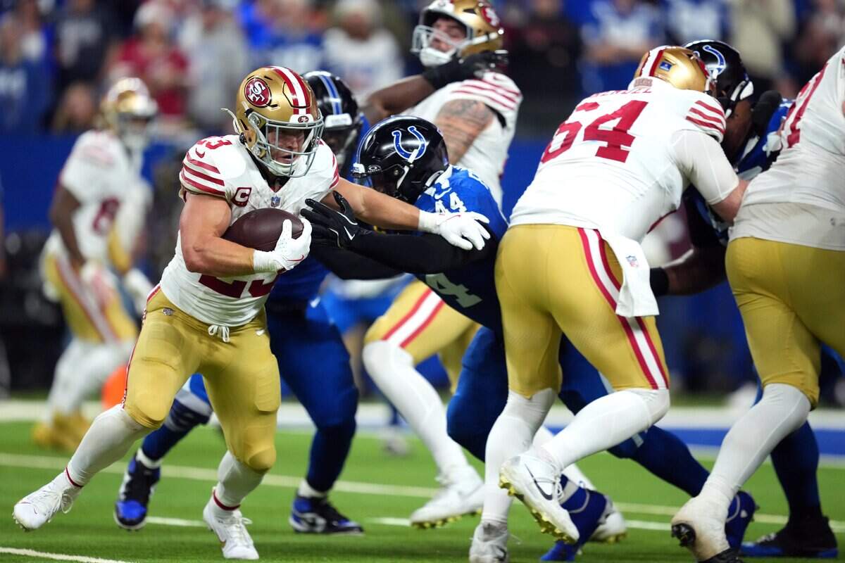 Running back Christian McCaffrey of the San Francisco 49ers rushes during the fourth quarter of the game against Zaire Franklin of the Indianapolis Colts at Lucas Oil Stadium on Monday in Indianapolis.