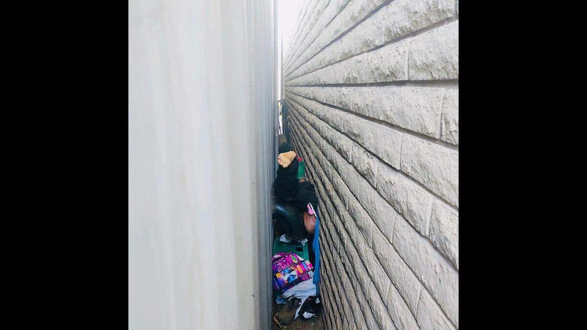 Phoenix firefighters rescue a man who became trapped Sunday, April 24, between a shipping container and a wall after a fall, Arizona officials say.