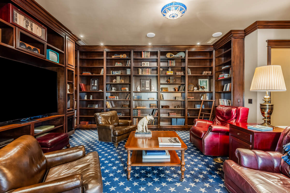 Custom cherry built-ins and a bar give the home’s library a clubby feel — one of several spaces the owners themed around presidents and early American history.