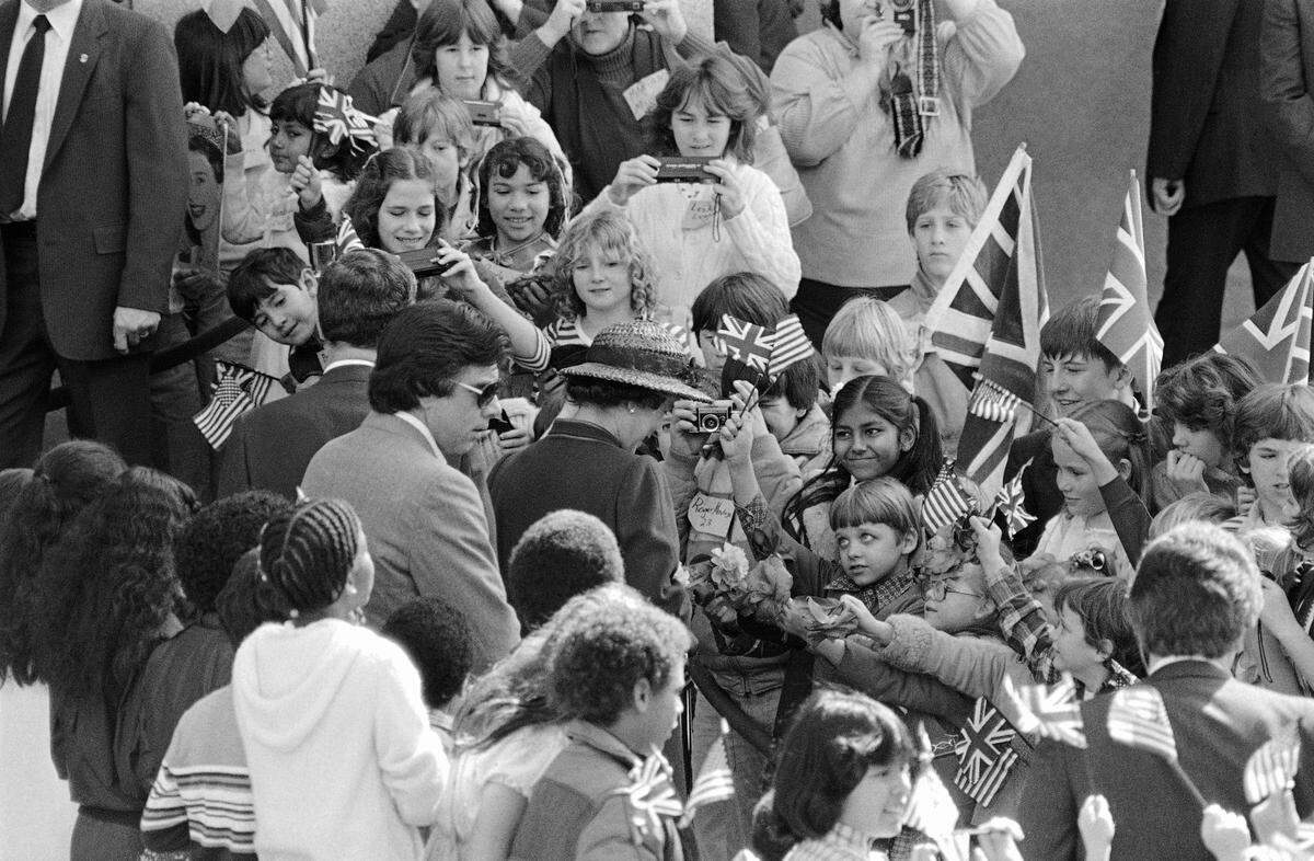 Queen Elizabeth II is greeted by youngsters outside the Capitol where she arrived for a visit with state lawmakers and California Gov. George Deukmejian.