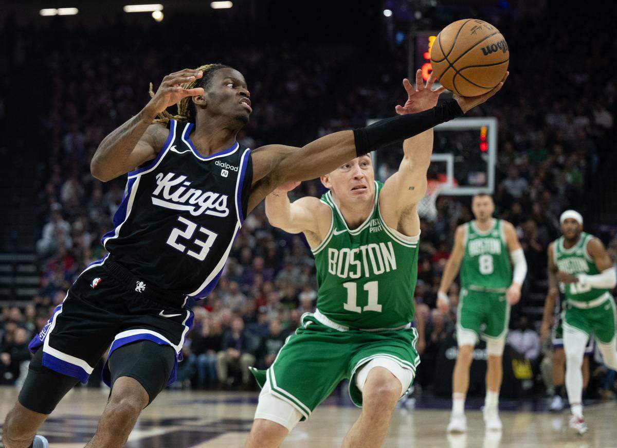Sacramento Kings guard Keon Ellis (23) and Boston Celtics guard Payton Pritchard (11) battle for a loose ball during Golden 1 Center in December.