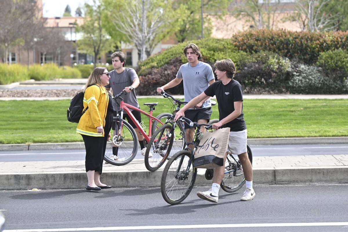 People watch police activity on Pleasant Grove Boulevard in Roseville near Mahany Park after reports of a shooter in the area on Thursday. A suspect was taken into custody, according to police dispatch audio.