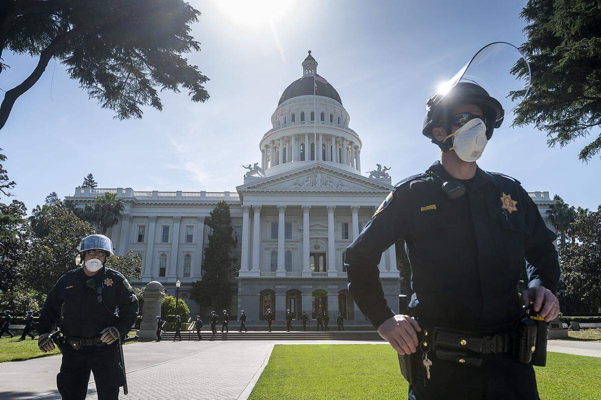 California Highway Patrol officers guard the state Capitol grounds during a protest on Thursday, May 7, 2020 in Sacramento during the coronavirus pandemic.