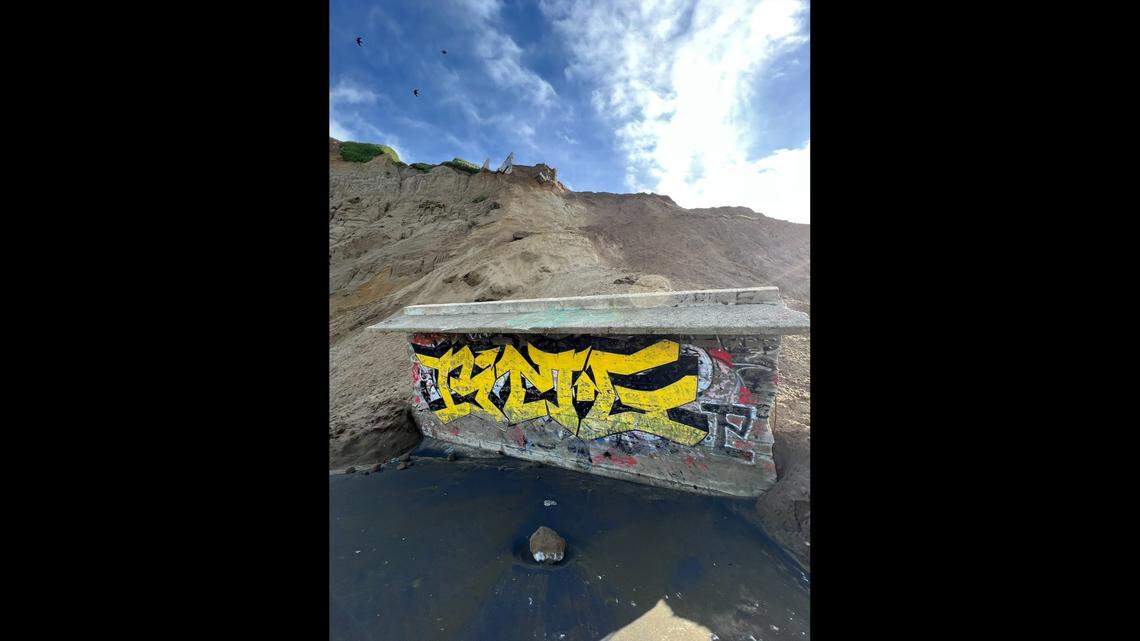 A massive World War II-era military structure tumbled 200 feet down from a sandy cliff onto a California beach, officials said.