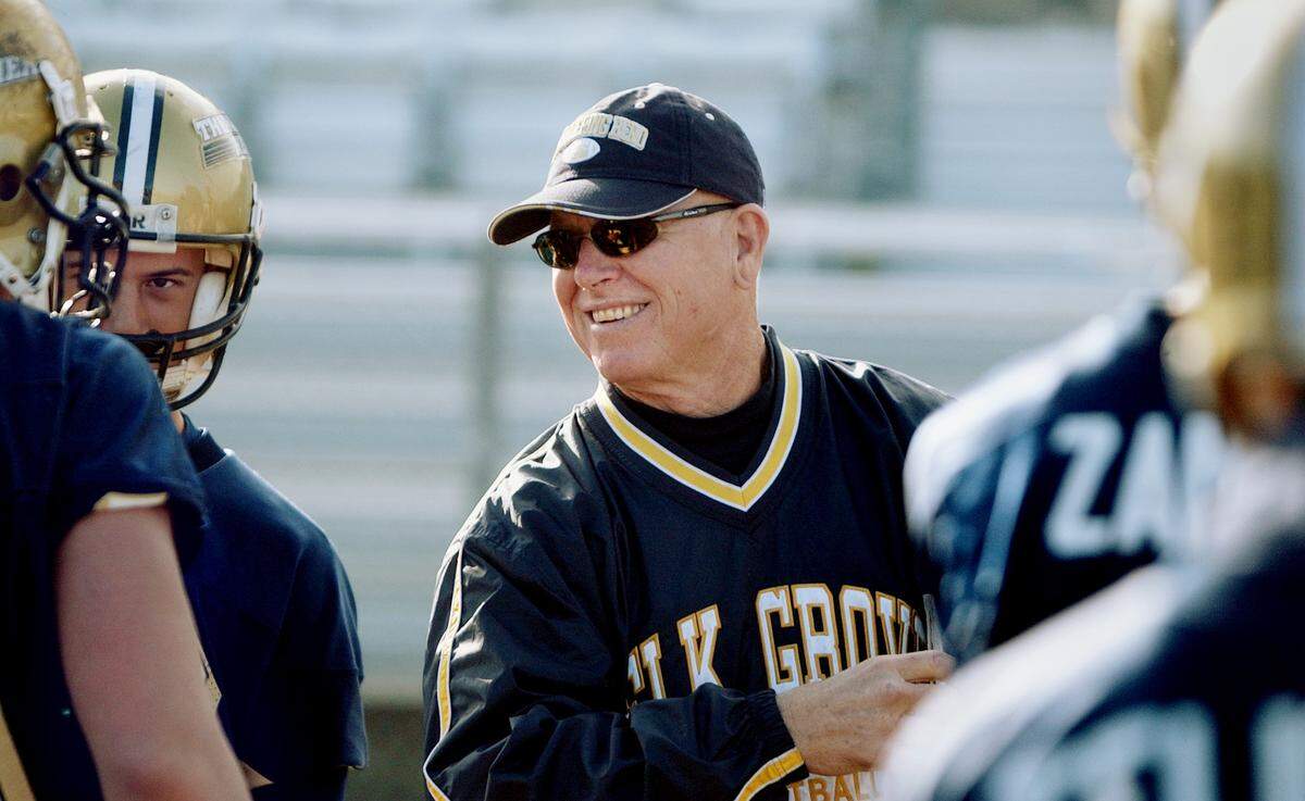Rick Swan, assistant football coach at Elk Grove High School, smiles at his players during practice in 2004. Swan died on Nov. 27 at 81.