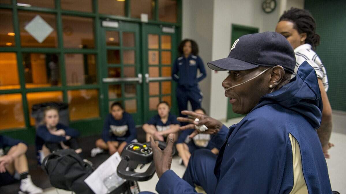 Elk Grove girls basketball coach Larry Price talks with his players before a loss to Granite Bay in the Sac-Joaquin Section Division II playoffs Feb. 20. Price died Monday in Sacramento, he was 61.