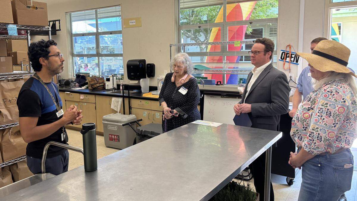 Alejandro Gomez, left, gives a presentation Thursday about the Community Food Connections program that he manages for Alchemist CDC. Taylor Kayatta, a trustee for the Sacramento City Unified school board, stands third from right.