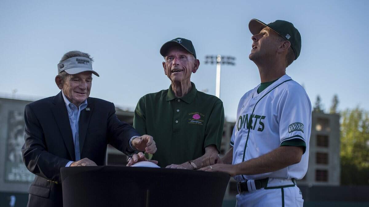 Former Sacramento State head coaches John Smith, left, and Cal Boyes, middle, push a button on a podium near home plate to turn on the lights with current head coach Reggie Christiansen, right, at Sacramento State’s first night game at John Smith Field on May 17, 2016. The Hornets play host to UC Davis under the lights on March 12, 2019.