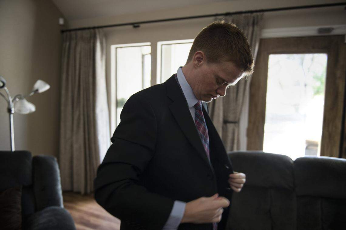 Evan Minton, a Sacramento-area transgender activist, buttons his suit jacket in 2016. Minton and the ACLU sued Dignity Health in 2017 after a Carmichael hospital canceled his hysterectomy, an important part of his gender transition.