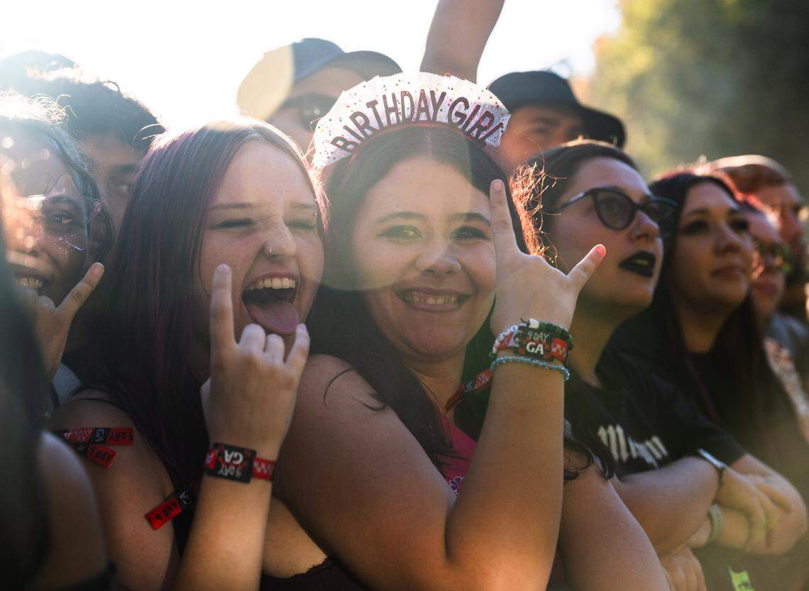 Birthday girl Judith Baker, 18, and her friend Jayden Lee, 17, wait for the next performance during the Aftershock festival on Friday, Oct. 3, 2025, in Discovery Park in Sacramento. The locals arrived around noon to claim their spot at the front. 