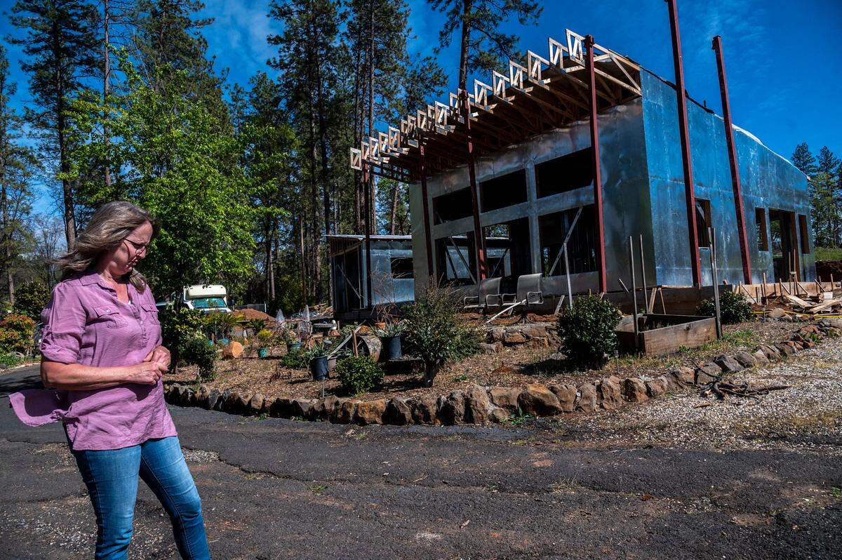 Skeeter Schuette says the most recent construction on her home was three months ago when Tricia Cohen of Cubic Quarters found a company to erect vertical steel beams outside the structure in Paradise on Wednesday, March 9, 2022. She has been living in a bus while struggling with the contractor to complete her home for the past three years.