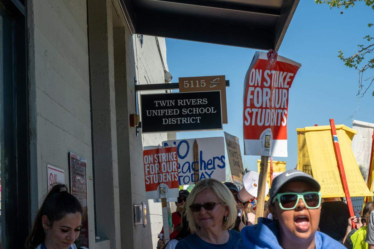 More than a 1,000 teachers and parents rallied at the Twin Rivers Unified School District office at McClellan Park on Friday, pounding on the entrance door and marching past it while demanding that the district return to the table as the teacher strike reached its 12th consecutive day.