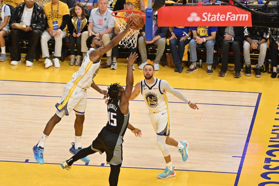 The Golden State Warriors’ Andrew Wiggins blocks a shot by Sacramento Kings’ Davion Mitchell during the second half of Game 4 of the first-round NBA playoff series at Chase Center in San Francisco on Sunday.
