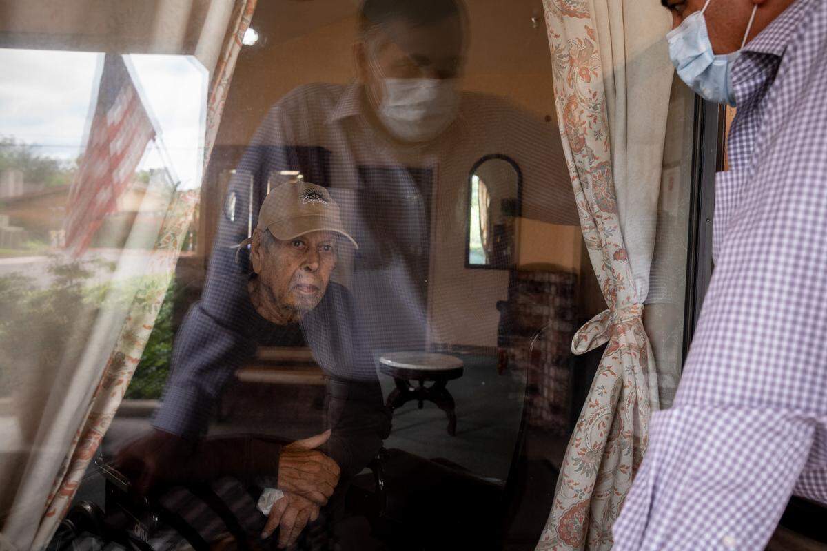 Ajaib Dosanjh, 87, is visited by his son, Dr. Raj Dosanjh, of Fresno, at City Creek Post Acute on May 14, 2020, in South Sacramento. “I used to come here every weekend,” the younger Dosanjh said, discouraged after weeks of restricted contact due to coronavirus precautions. “He’s lost weight, he’s not eating, getting depressed because there’s no family contact,” he added, “he has dementia, too, so he doesn’t realize what’s happening out here.”