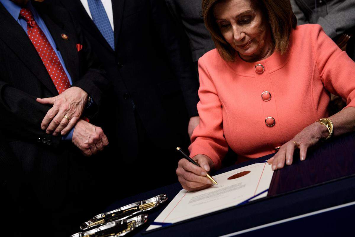 Speaker of the House Nancy Pelosi, D-Calif., signs articles of impeachment of President Donald Trump during an engrossment ceremony on Capitol Hill on Jan. 15, 2020, in Washington, D.C. The House voted to transmit articles of impeachment against President Donald Trump to the Senate, opening the way for the historic trial of the 45th president for abuse of power.