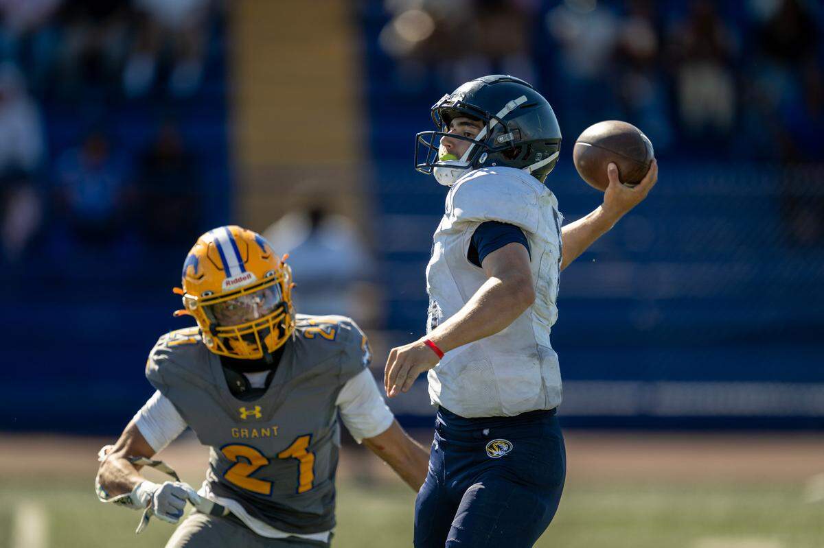 The Grant Pacers’ Gary Tia (21) closes in on Inderkum Tigers quarterback Ricky Cole (6) in the second half on Sept. 7 at Grant High School.