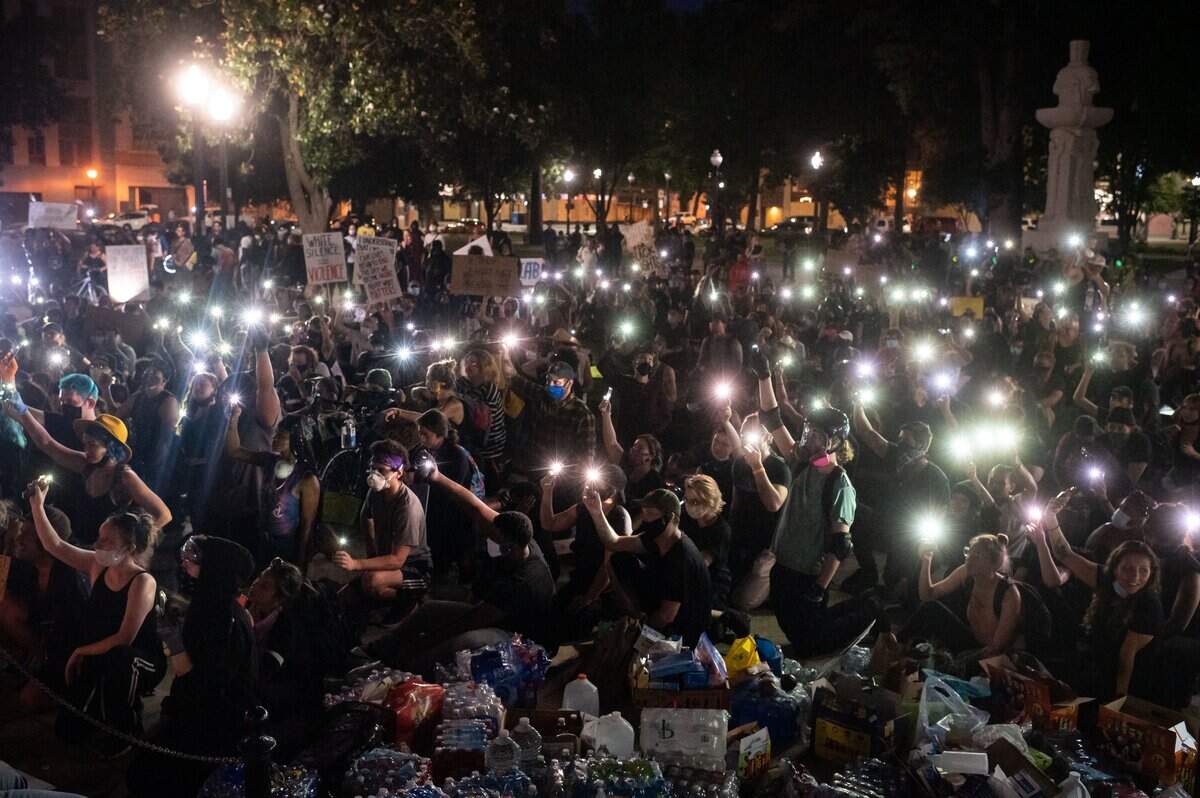 17. Demonstrators against police brutality and racism hold up their cell phones in a peaceful protest Tuesday, June 2, 2020, at Cesar E. Chavez Plaza in Sacramento after George Floyd was killed by Minneapolis police last week, sparking civil unrest across the country. The California National Guard was on hand after an 8 p.m. curfew was implemented Monday.