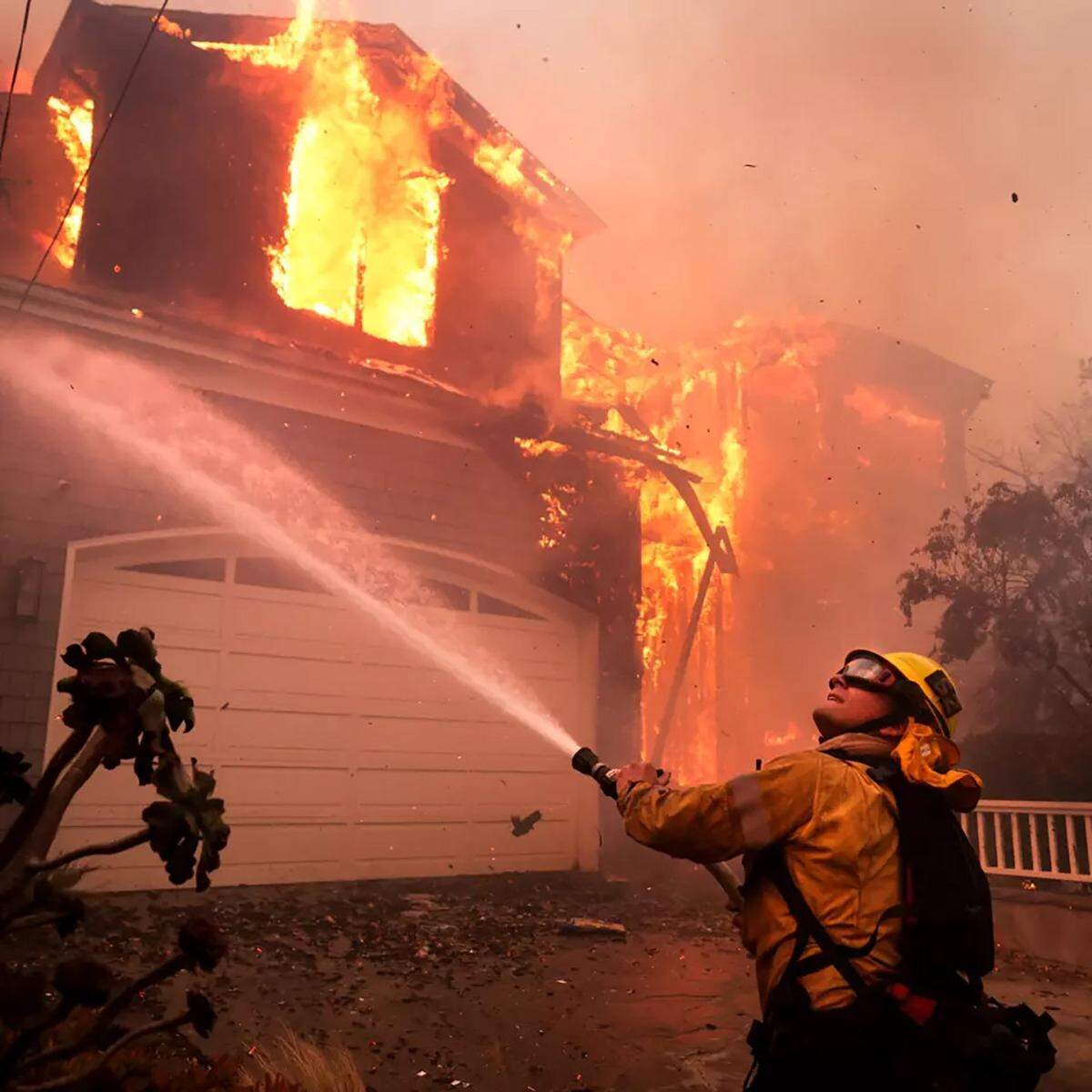 Firefighters battle a house fire off Bollinger Drive in Pacific Palisades on Tuesday, Jan. 7, 2025. (Wally Skalij/Los Angeles Times/TNS)