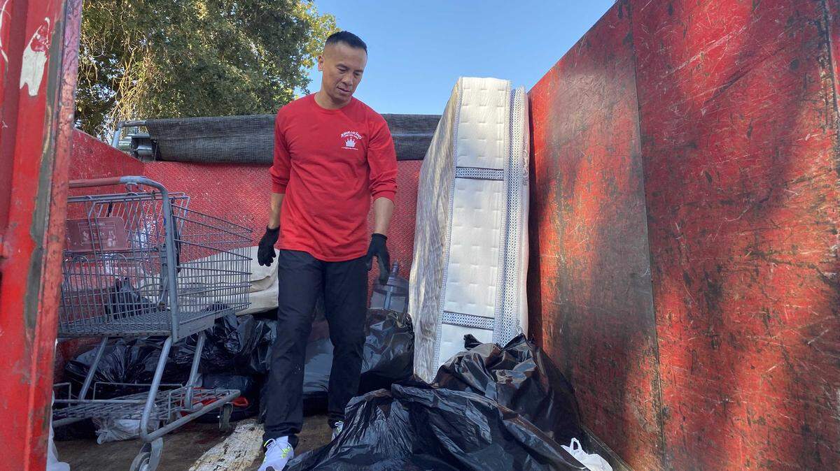 Khamsone Manisisaket, an assistant general manager at Junk King, climbed into one of the junk removal company's trucks on Saturday to pack in garbage collected by volunteers at the Great American River Clean Up in Sacramento.