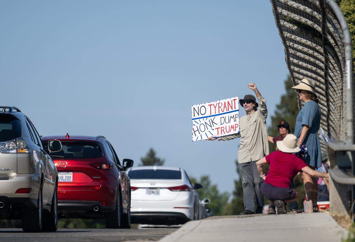 Protesters demonstrate against President Trump and his policies at the Interstate 5 overcrossing at Pocket Road in Sacramento on Saturday.